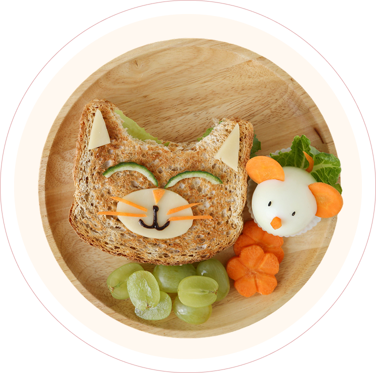 Cat-shaped sandwich with fruit and vegetables.