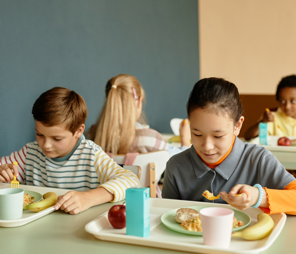 Children eating lunch at school cafeteria.